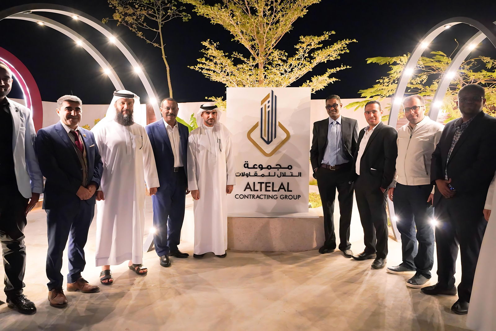 Al Telal staff at the annual gathering in front of the company brand wall
