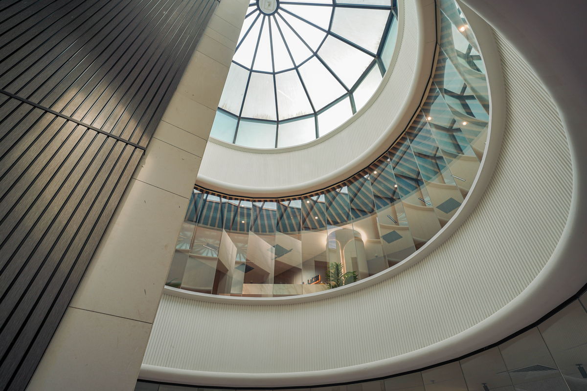 The glass-domed atrium and spiral stair at Business Square, Ajman